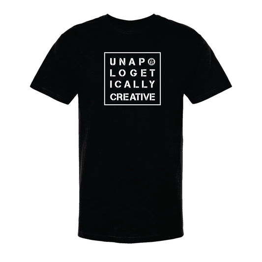 A black unisex crew neck t-shirt with the text 'UNAPOLOGETICALLY CREATIVE' printed in white on the front.