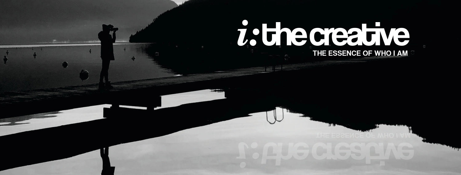 Black and white portrait-style graphic with a silhouetted person standing on a dock over calm water, with large white text reading 'i: the creative' and smaller text 'THE ESSENCE OF WHO I AM'.